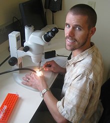 Gabe Hamer at a microscope